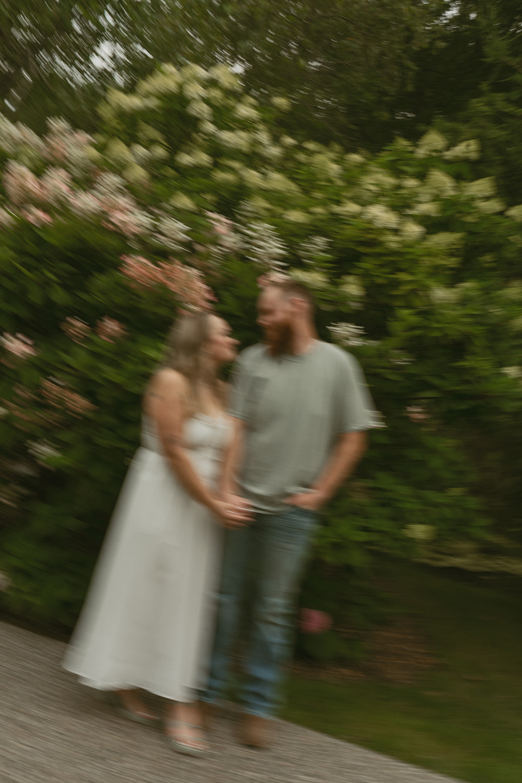 couple walk the path together during their dow gardens engagement photos